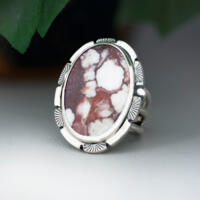 3/4 view facing left large oval wild horse magnesite gemstone silver statement ring, bezel set with stamped cutout wire accent